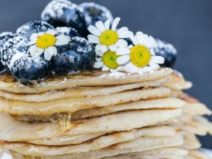 Stack of pancakes topped with blueberries