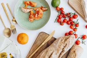 Healthy breakfast with toast, tomatoes, and fresh ingredients on a table