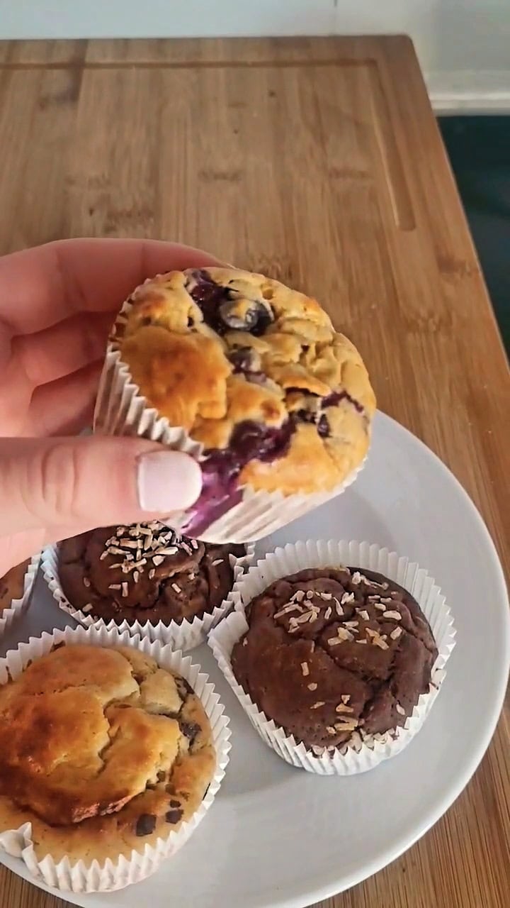 banana protein muffin held in hand close to the camera