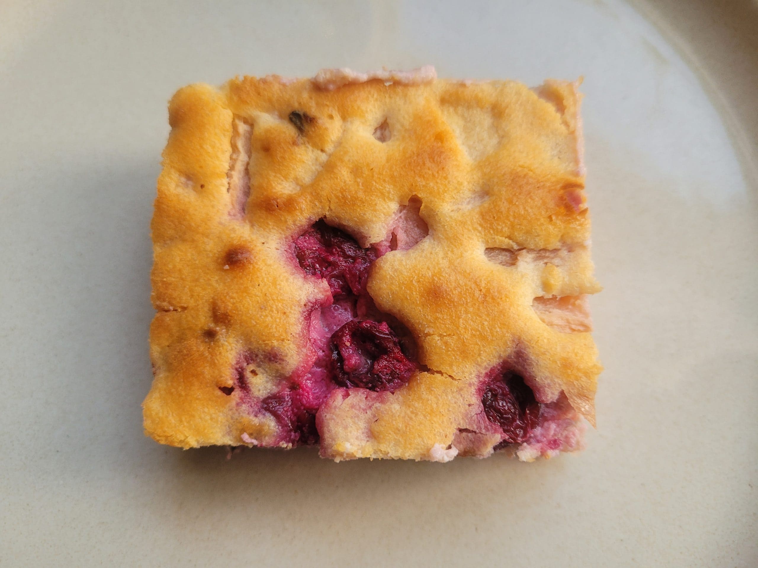 slice of apple cranberry greek yogurt cheesecake on a plate