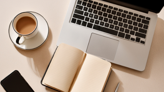 Open notebook and laptop on a desk