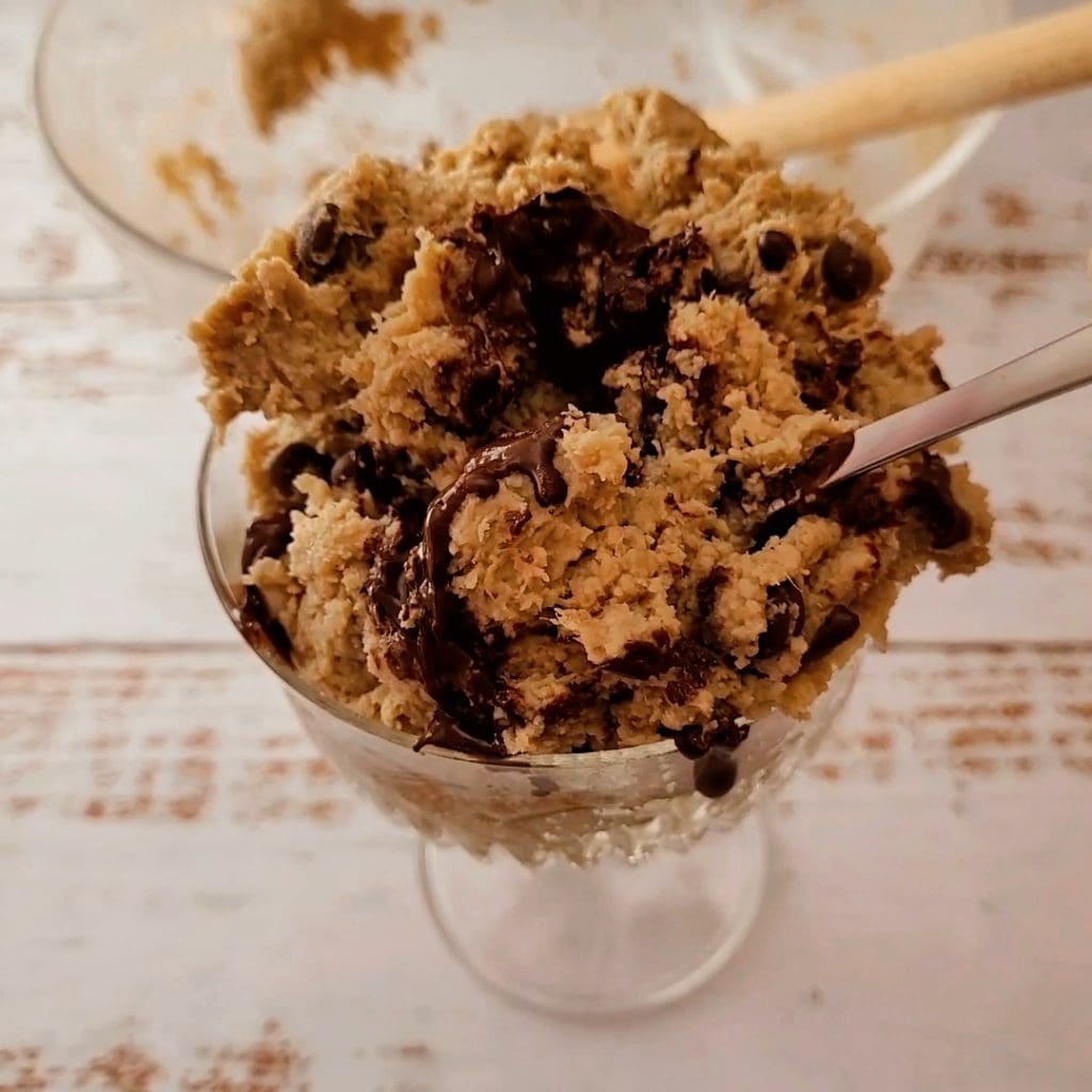 vegan protein cookie dough in a glass topped with melted dark chocolate creamy healthy dessert