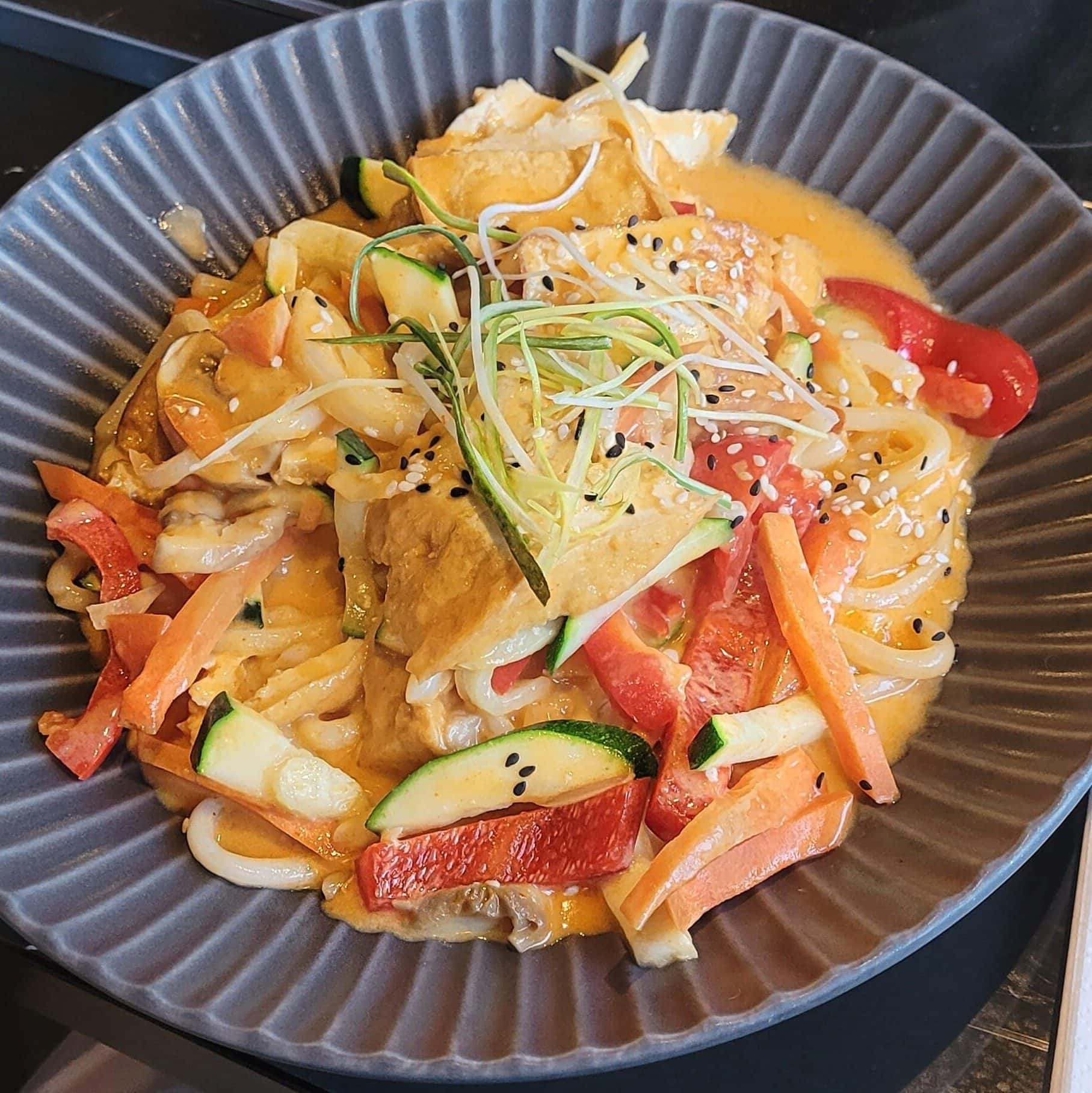 vegetarian curry bowl with protein toppings and rich sauce