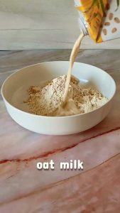 Oat milk poured into bowl for Easy Homemade Protein Bars
