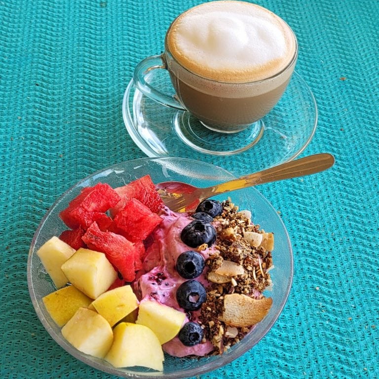Healthy Greek yogurt bowl with fresh watermelon, melon, blueberries, and crunchy granola. Perfect fo.
