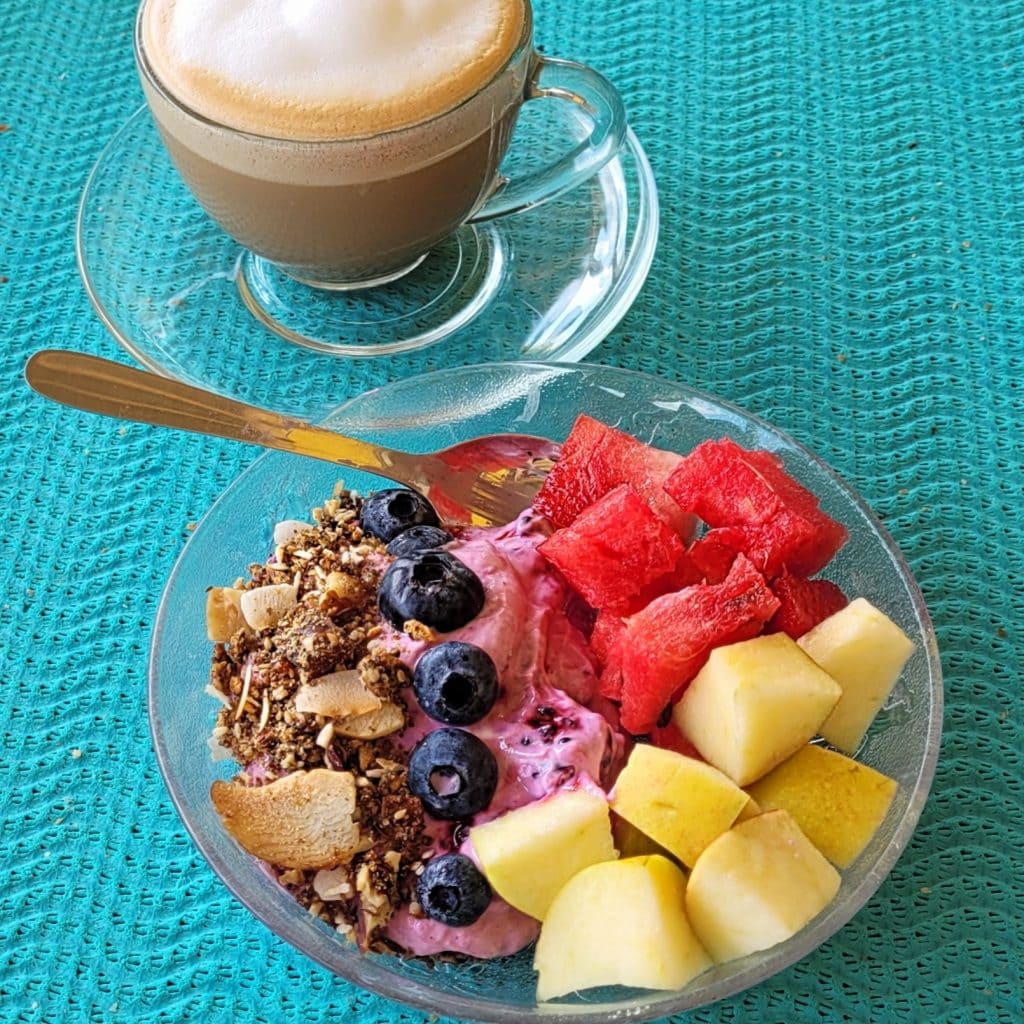 Breakfast yogurt bowl with Greek yogurt, blueberries, watermelon, melon, and granola.