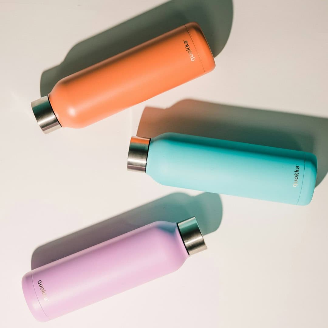Water bottles for fitness and hydration, pastel colors, on white background.