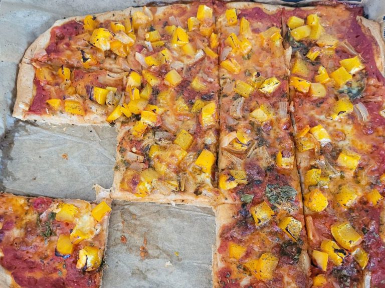 Vegetarian pizza topped with yellow bell peppers and vegetables for a healthy diet.