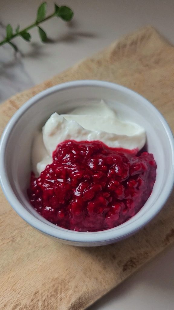 Healthy raspberry Greek yogurt dessert topped with dark chocolate.