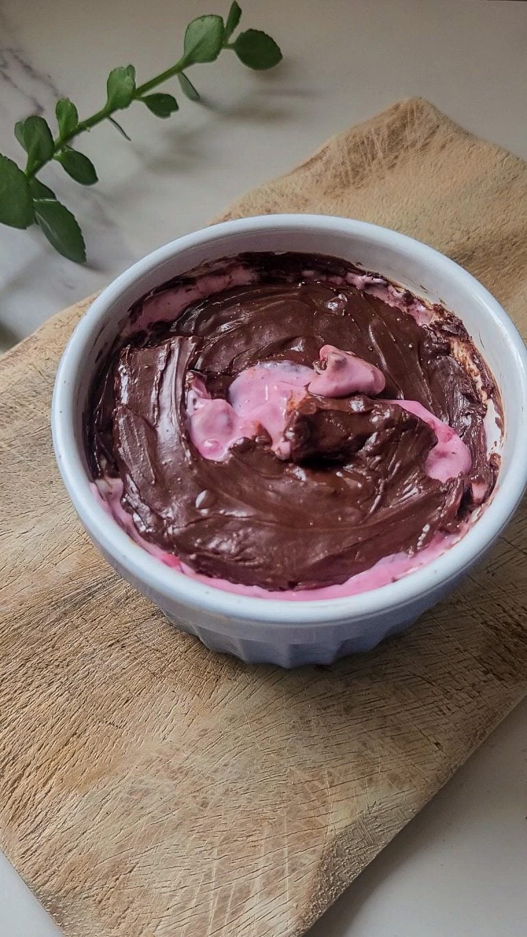 Creamy Greek yogurt dessert with a crunchy chocolate shell in a white bowl.