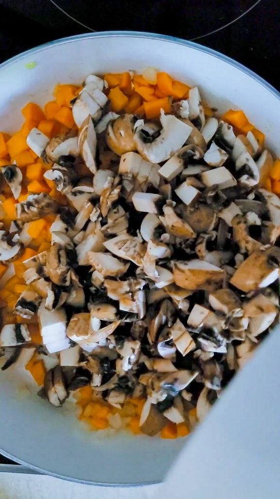 mushrooms mixed with carrots in a pan
