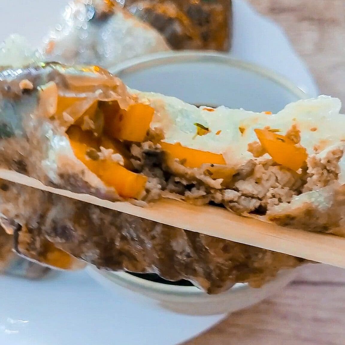Close-up of stuffed bell peppers with ground meat and vegetables.