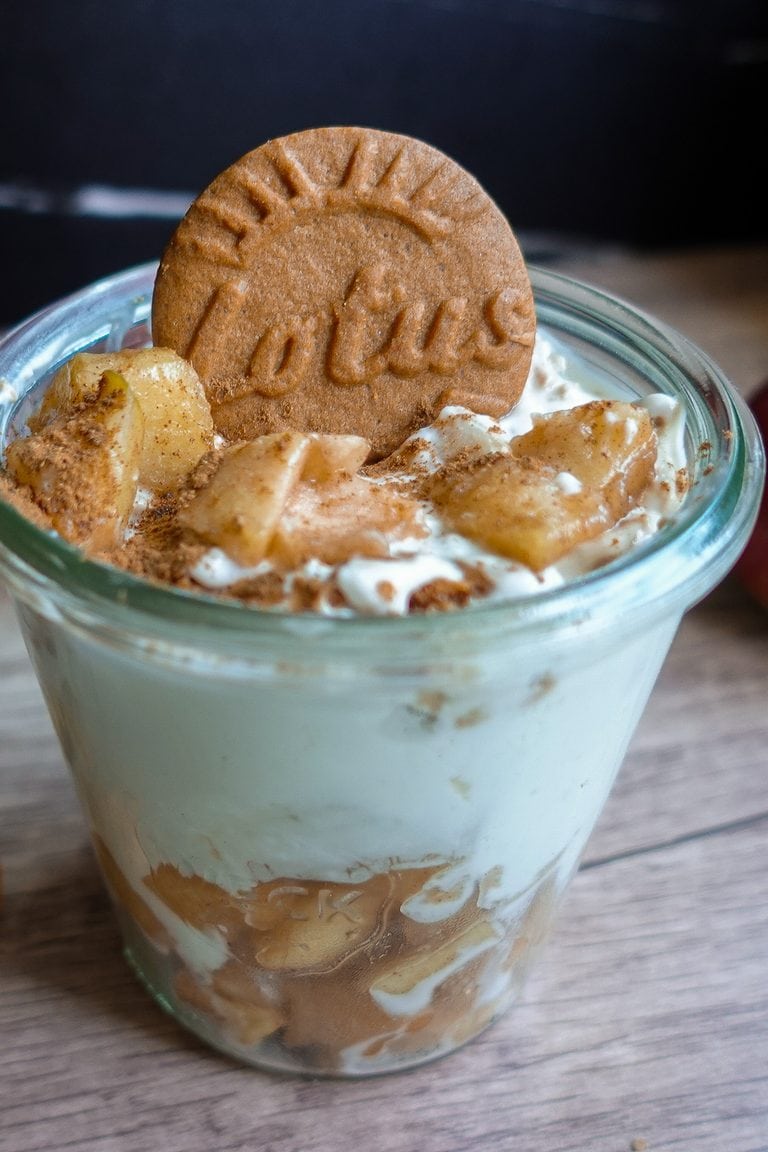 Delicious Biscoff Greek Yogurt Cheesecake with cinnamon apples in a glass.
