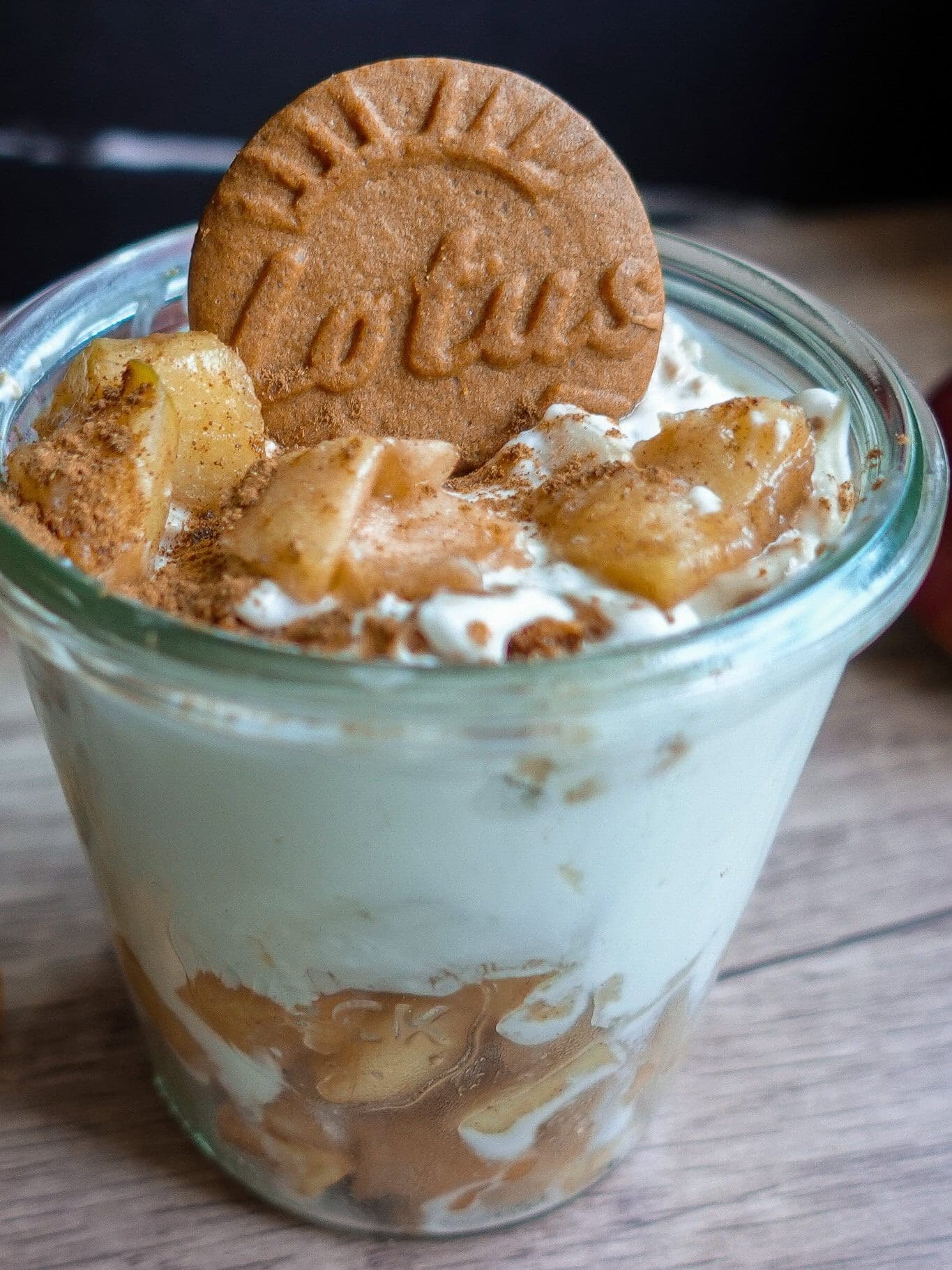 Delicious Biscoff Greek yogurt cheesecake with cinnamon apples in a glass.