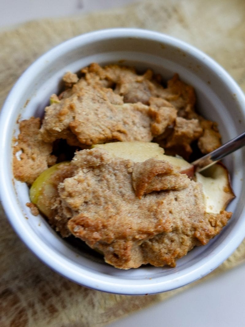 Delicious homemade apple crumble dessert in a small bowl.