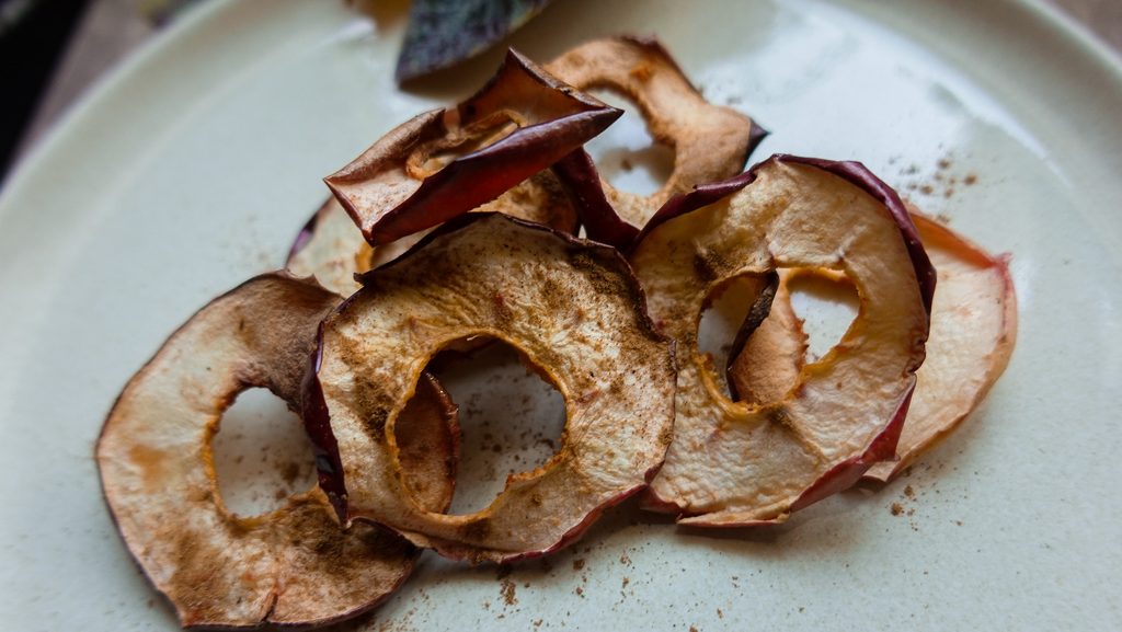 Crispy apple chips prepared in an air fryer for a healthy snack.