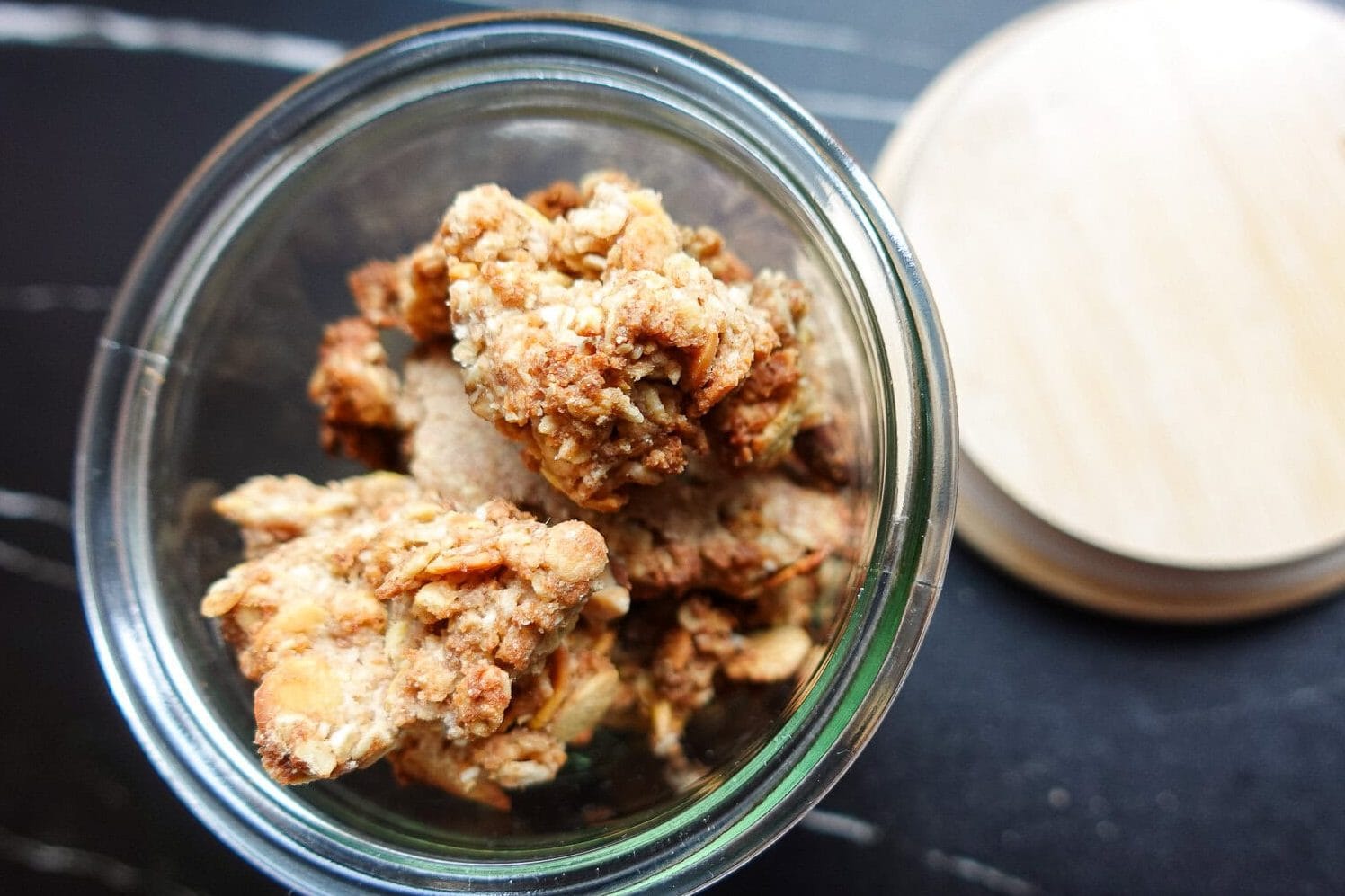 Close-up of homemade oat crumble topping in a glass jar.