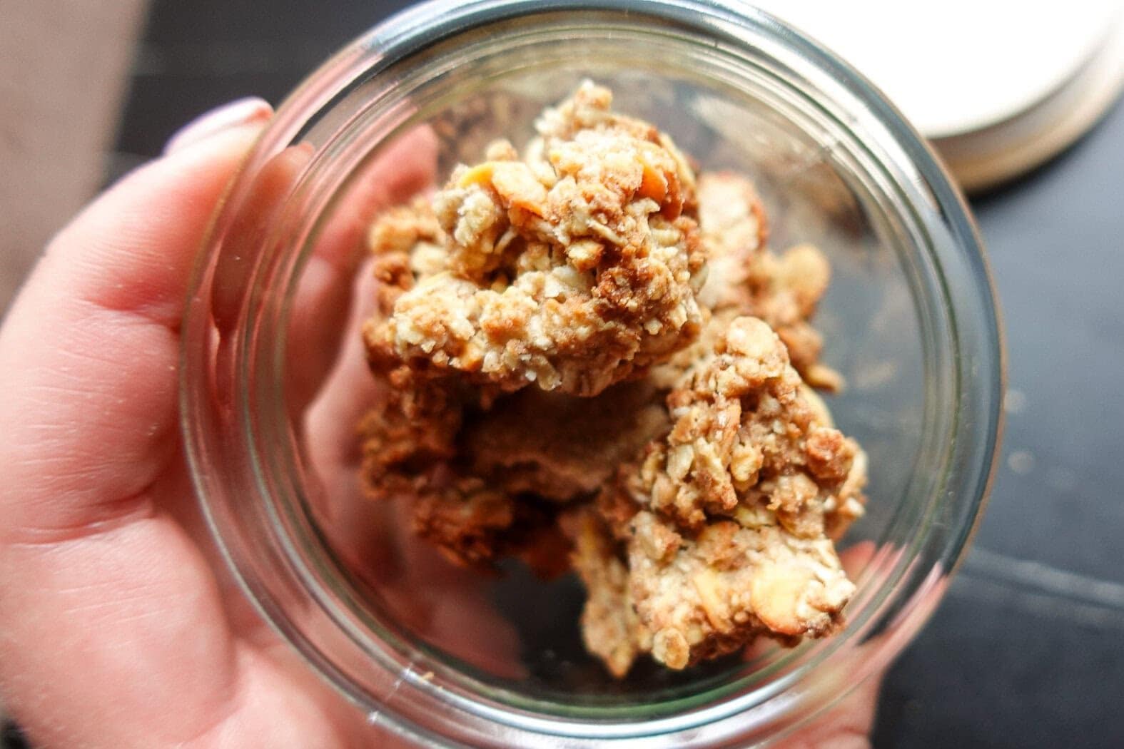 Close-up of homemade oat crumble in a glass jar for dessert.