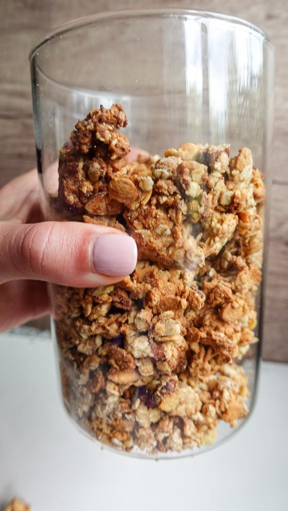 Close-up of crunchy homemade granola clusters in a glass.